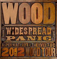 A rare, vintage-style poster with the text "WIDESPREAD PANIC - WOOD (PREOWNED CD) tour" listing tour cities like Aspen, Atlanta, and Denver.