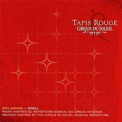 Album cover for "CIRQUE DU SOLEIL - TAPIS ROUGE (PREOWNED CD)," featuring a red background with a subtle star pattern and white text detailing the album's title and music information, styled to resemble vinyl records.