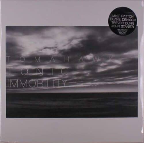 Cover of TOMAHAWK - TONIC IMMOBILITY (COKE BOTTLE CLEAR VINYL LP) featuring a grayscale stormy sky over a calm sea horizon, with the band's name and album title at the bottom.