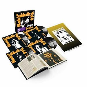 The image captures the contents of a BLACK SABBATH - VOL.4 (5LP VINYL BOXSET). It includes five vinyl records showcasing the band's name and images on the covers, an open book with band history and photos, and a poster featuring black-and-white images of the band members on a gold background—perfect for any turntable enthusiast.
